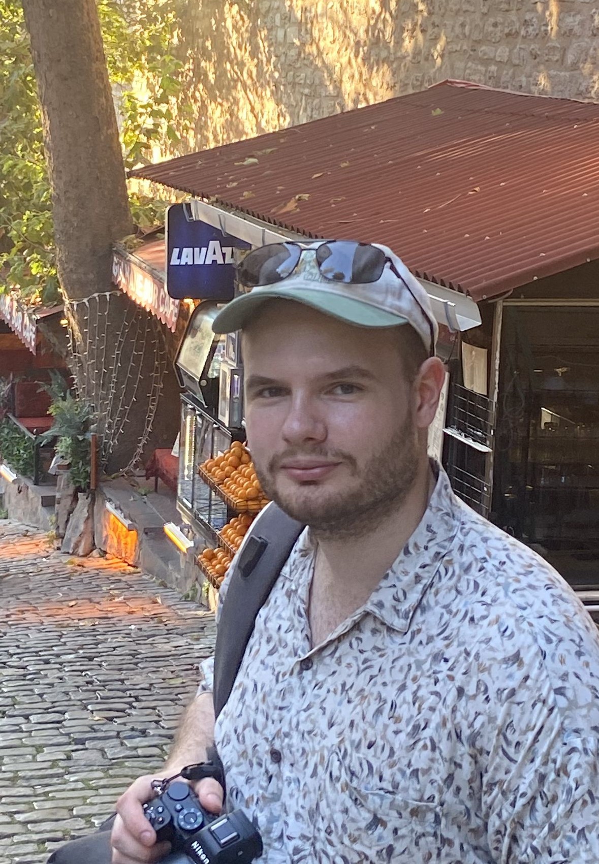 Dmitry Pronin holding a camera outdoors